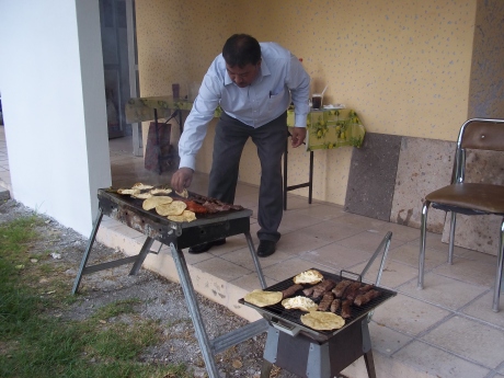 Marco tends the chorizo, marinated beef and tortillas on the grill (the anafre).